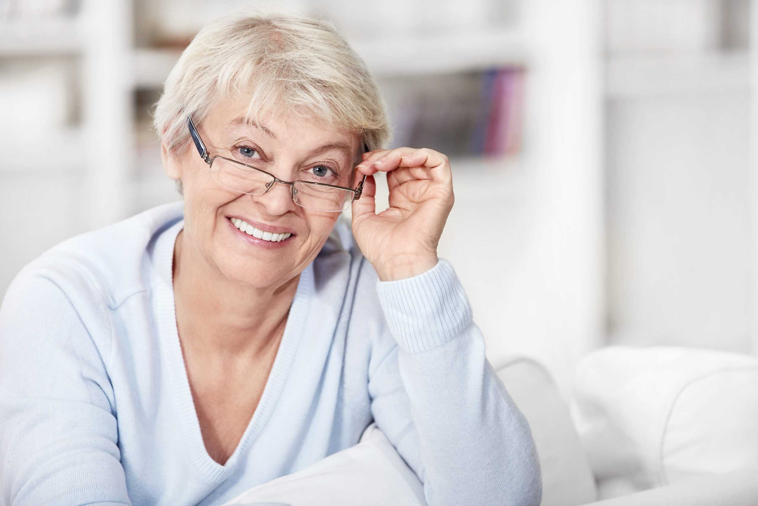 Mature woman with glasses at home